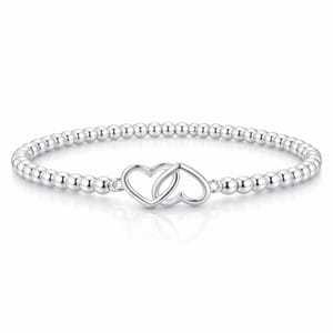 A silver bracelet featuring small round beads and an intertwined double heart charm centerpiece.
