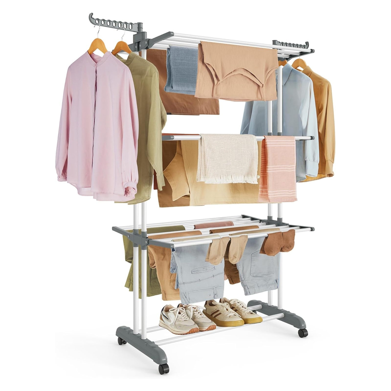 A multi-tiered clothes drying rack with rolling wheels, holding shirts, pants, and shoes. It features several rods for hanging garments and additional space for items like shoes or small accessories.