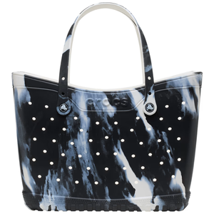 A black and white marbled tote bag with perforated holes and two handles, featuring the Crocs logo on the front.