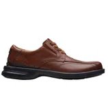 Men's brown leather lace-up dress shoe with a black sole and subtle stitching details.