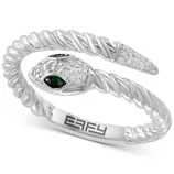 A silver snake-inspired cuff bracelet with a twisted design features green gemstone eyes and a textured surface with small clear stones. The brand name \“EFFY\“ is engraved on the inside.