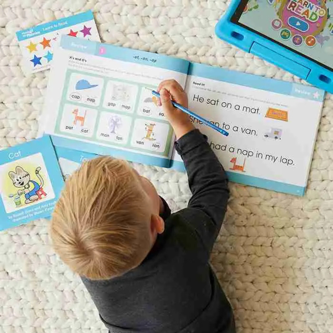 A child uses a Hooked on Phonics workbook and tablet app, focusing on early reading skills with activities like matching words and completing sentences. The set includes visual aids, engaging exercises, and colorful illustrations for effective learning.