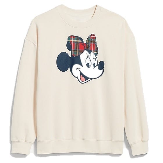 Cream-colored sweatshirt featuring a graphic of an animated character with a plaid bow.
