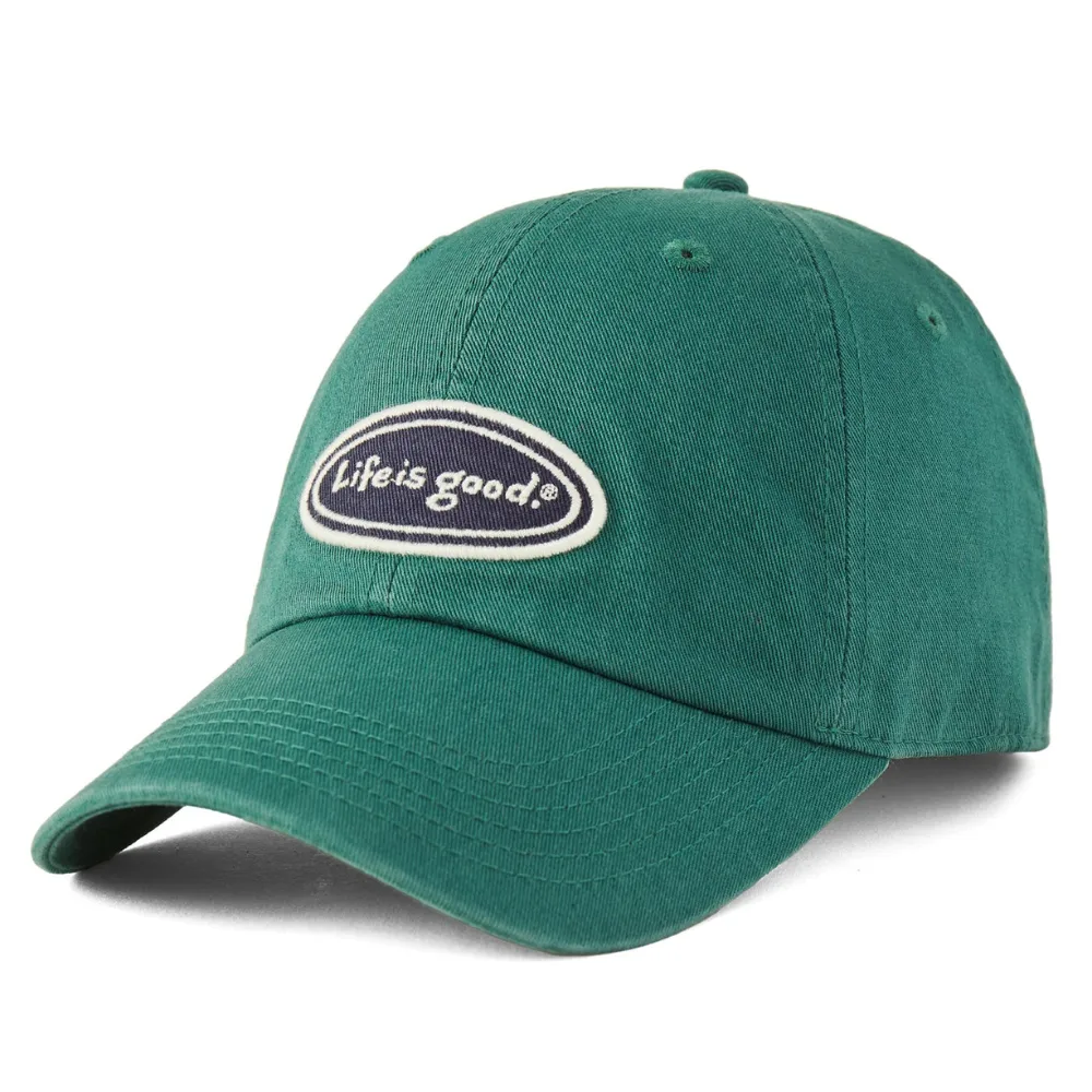 Green baseball cap with an oval patch that reads \“Life is good.\“