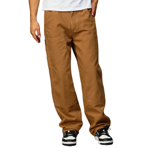 Brown workwear-style pants with a loose fit and visible stitching details, paired with black and white sneakers.