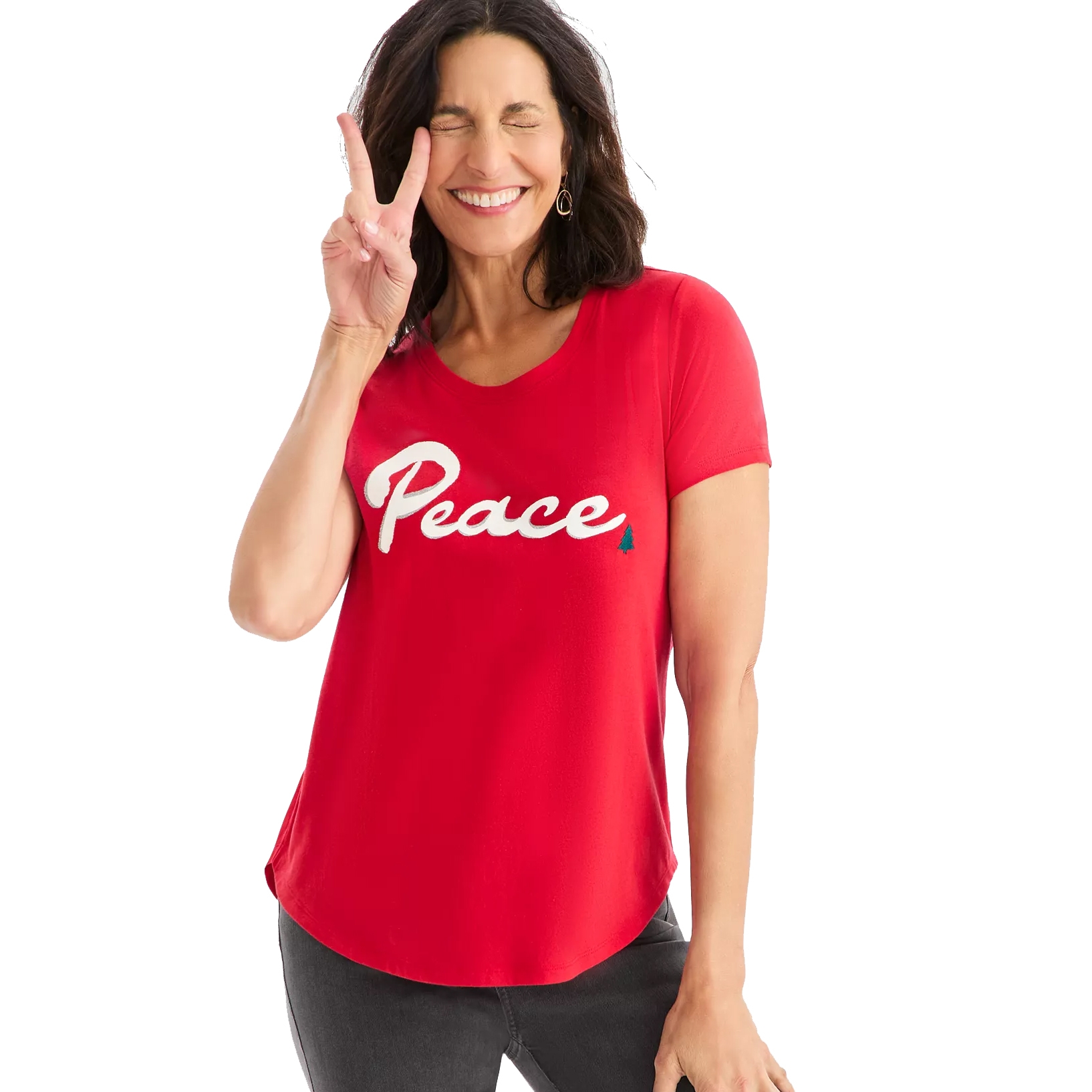 A person wearing a red T-shirt with the word \“Peace\“ printed in white. The person is smiling and making a peace sign with their fingers.