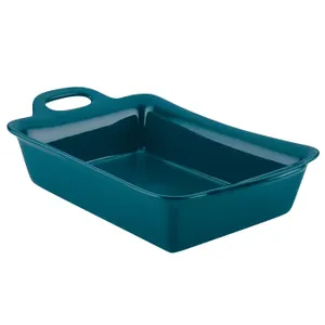 A teal ceramic baking dish with a built-in handle.