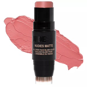 NUDESTIX Nudies Matte All Over Face Blush Color in a soft pink shade, packaged in a stick with a built-in blending brush.