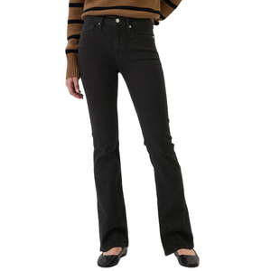 Black bootcut jeans paired with a brown and black striped sweater and black flats.