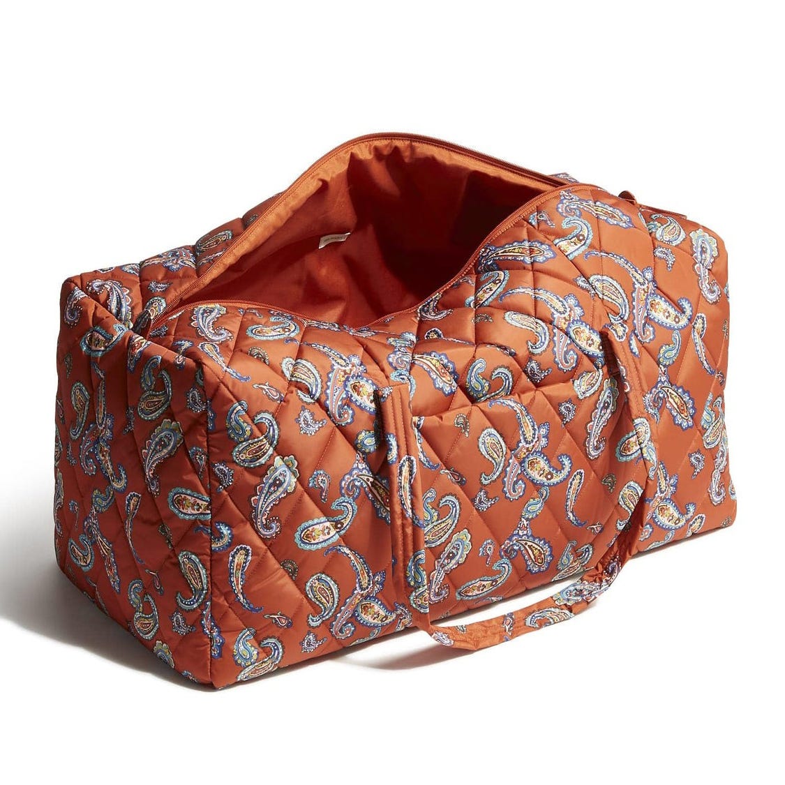 An orange quilted duffel bag featuring a paisley pattern and dual handles, with an open top showing a spacious interior.