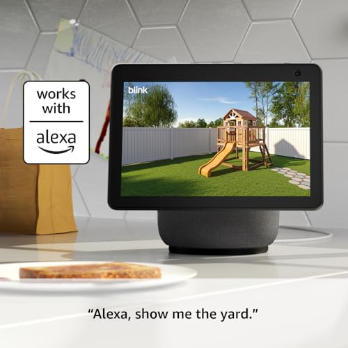 A smart display shows a live camera feed of a yard with a playset, alongside a label indicating compatibility with Alexa. A voice command, \“Alexa, show me the yard,\“ is displayed below.