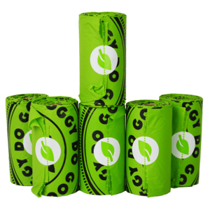 Green rolls of biodegradable dog waste bags with a leaf logo, branded as Doggy Do Good.