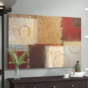 Abstract canvas wall art above a wooden dresser with decorative items including a vase with ferns and a tray with books.