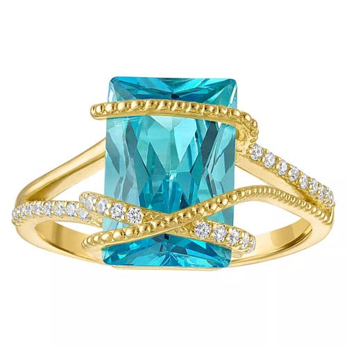 Gold ring with a large rectangular blue gemstone, accented with swirling gold bands and encrusted with small diamonds.