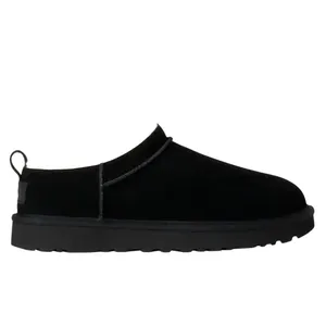 Black slip-on shoe with a fluffy interior lining and a pull tab at the heel.