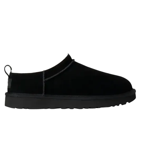 Black slip-on shoe with a fluffy interior lining and a pull tab at the heel.