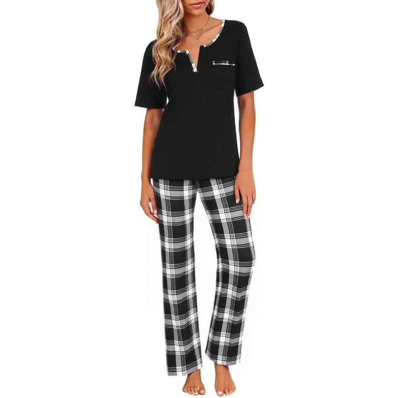 Women's pajama set featuring a black short-sleeve top with a plaid trim on the neckline and pocket, paired with black and white plaid pants.