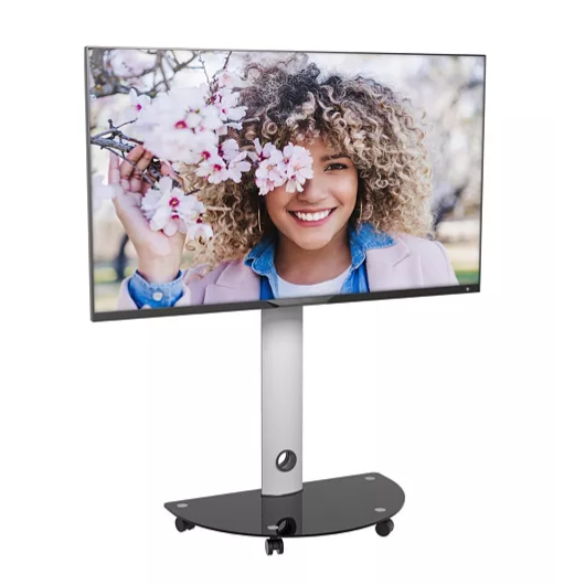 A large flat-screen TV on a sleek, silver stand with a black, wheeled base, displaying a woman smiling behind pink flowers.