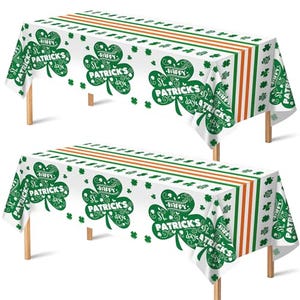 Two St. Patrick's Day themed tablecloths with green shamrock patterns and festive greetings on a white background.