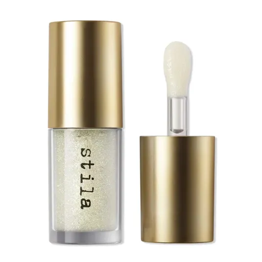 A glittery liquid eyeshadow with a gold cap and an applicator wand, labeled \“Stila.\“