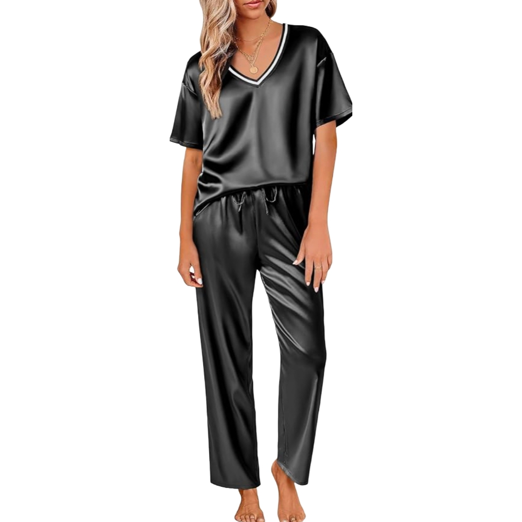 A woman is wearing a black satin pajama set with a V-neck short-sleeve top and loose-fitting pants.