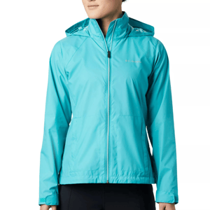 A person is wearing a turquoise blue, hooded, zip-up rain jacket with the Columbia brand logo on the chest.