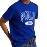 Royal blue t-shirt featuring \“POLO 1967\“ in large white lettering, paired with denim jeans and a striped belt. A small polo player logo is visible near the hem.