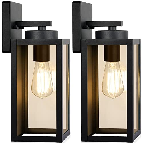 Two rectangular black outdoor wall lights showcasing exposed filament bulbs inside clear glass panels, mounted on a flat backing plate.