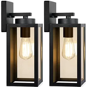 Two rectangular black outdoor wall lights showcasing exposed filament bulbs inside clear glass panels, mounted on a flat backing plate.