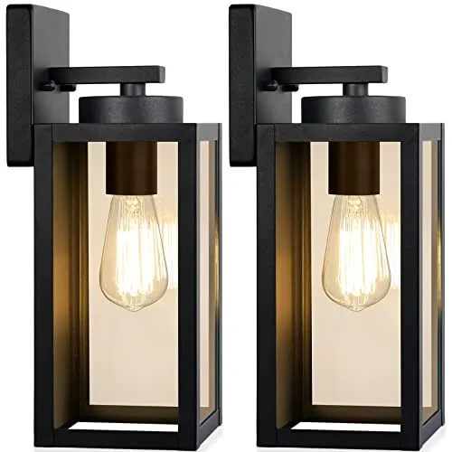Two rectangular black outdoor wall lights showcasing exposed filament bulbs inside clear glass panels, mounted on a flat backing plate.