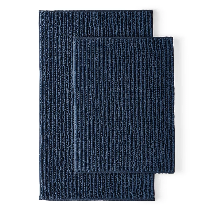 Two stacked navy blue bath rugs with textured patterns.