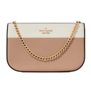A Kate Spade New York pochette featuring a color-blocked design with cream and blush tones, adorned with a gold chain strap and the brand's logo.