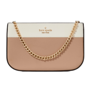 A Kate Spade New York pochette featuring a color-blocked design with cream and blush tones, adorned with a gold chain strap and the brand's logo.