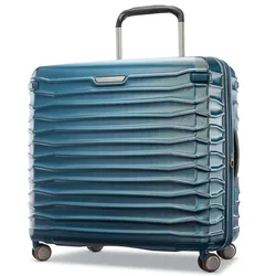 A blue hardshell suitcase with a textured horizontal rib design, featuring a telescopic handle and four multi-directional spinner wheels.