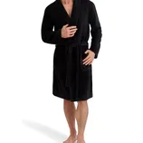 A man is wearing a black knee-length robe with a shawl collar and a belt at the waist. The robe also features two front pockets.