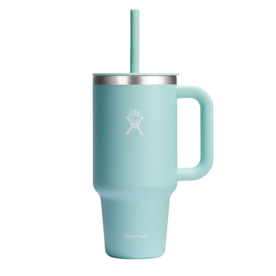 A light blue Hydro Flask mug with a handle and a straw, featuring the brand logo on the side.