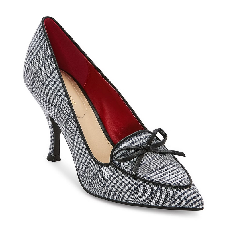 A single high-heeled shoe with a black and white houndstooth pattern and a red interior, adorned with a black bow on the toe.