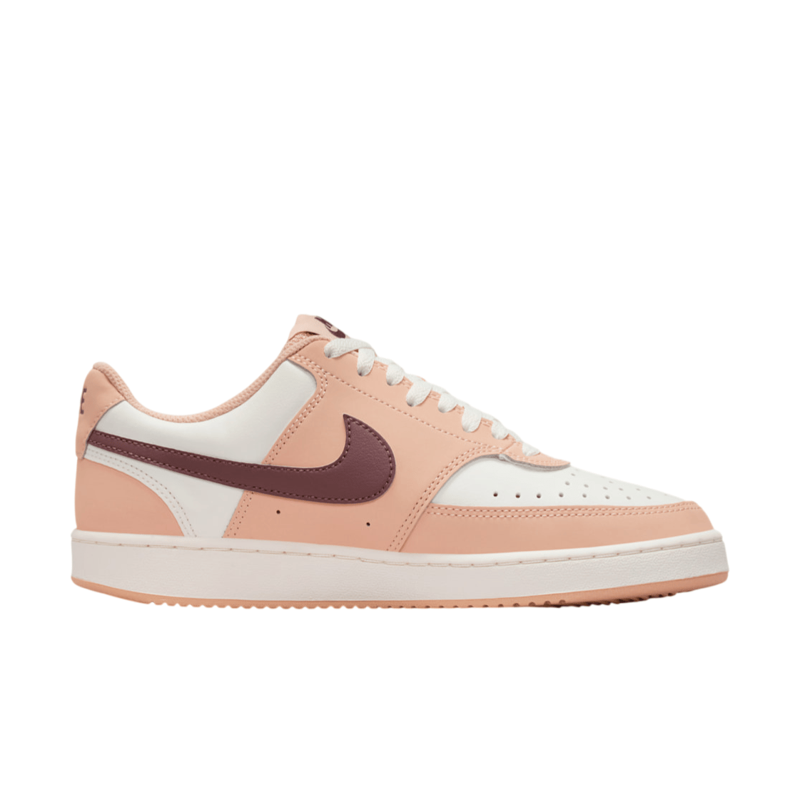 A low-top sneaker in peach and white, featuring a burgundy Nike swoosh on the side, with perforated detailing on the toe and a white sole.
