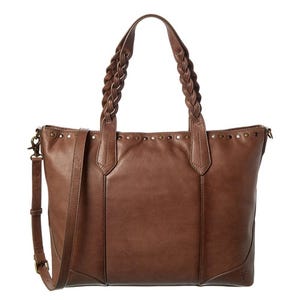 Brown leather tote with braided handles, a detachable shoulder strap, and metal studs along the top edge for decoration.