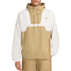A Nike Men's Anorak Jacket in tan and white with a half-zip front, hood, and kangaroo pocket. The Nike logo is on the chest, and the cuffs are elasticized.