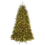 A pre-lit artificial Christmas tree with warm white lights, featuring lush green branches and a sturdy metal stand.