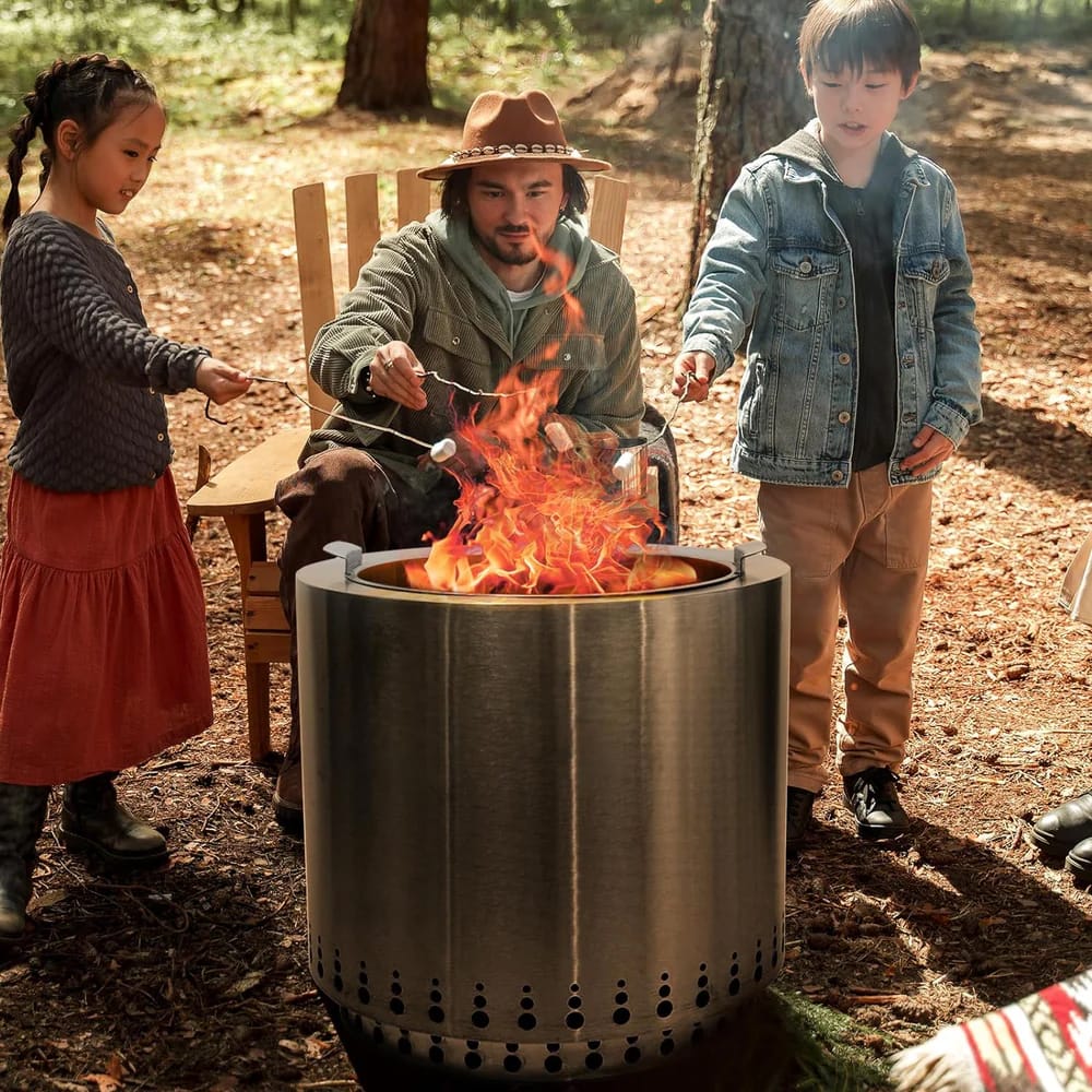 A portable fire pit with people roasting marshmallows.
