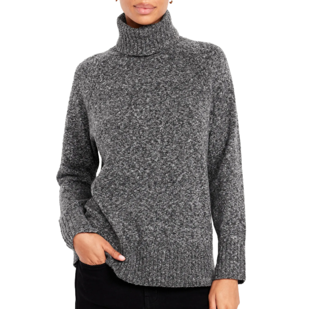 A person is wearing a gray turtleneck sweater with a textured knit and ribbed cuffs, paired with black pants.