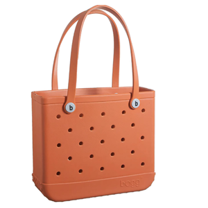 Orange tote bag with a perforated design, featuring circular holes and two handles.