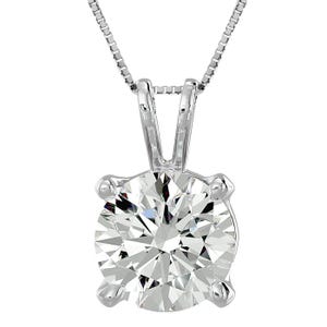 A silver necklace with a round-cut diamond pendant set in a four-prong setting.