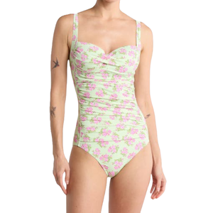 The Betsey Johnson Bandeau One-Piece Swimsuit features a light green base with a pink floral print, a sweetheart neckline, and adjustable shoulder straps. It includes subtle ruching for a flattering fit.