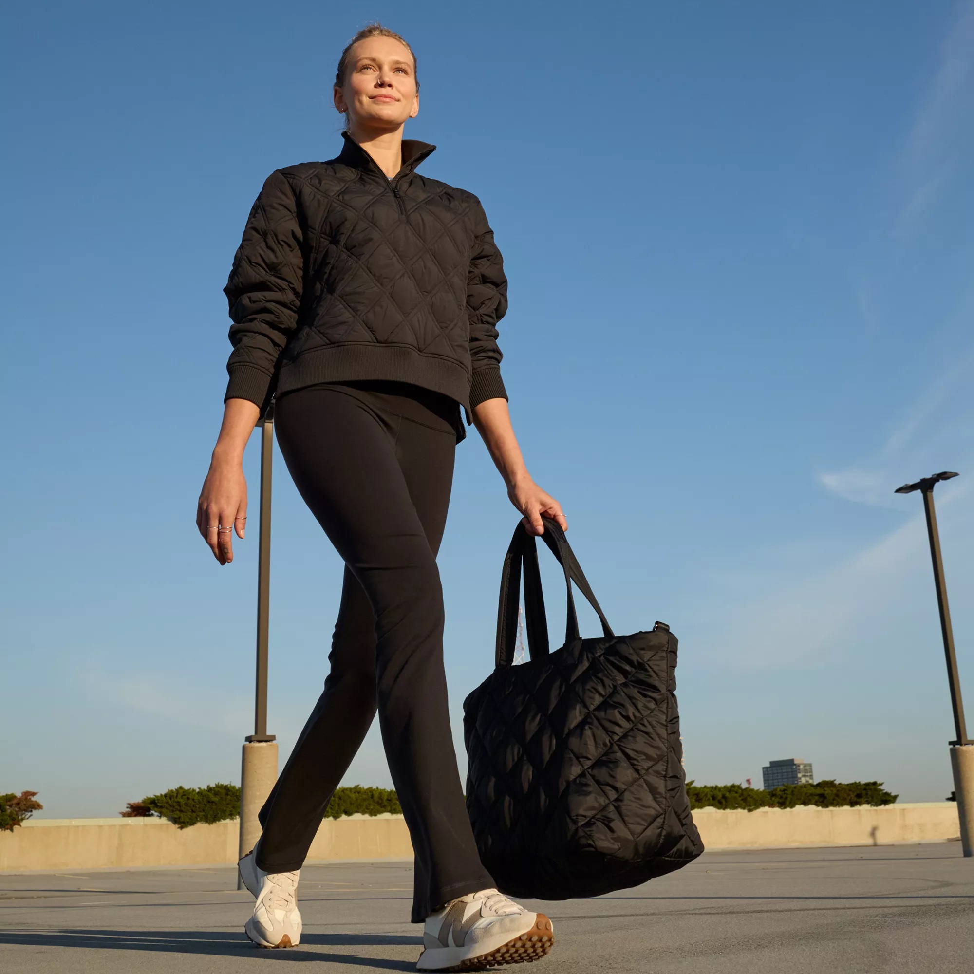 Black flare leggings sit snugly at the waist, tapering through the thigh and flaring out subtly at the bottom.