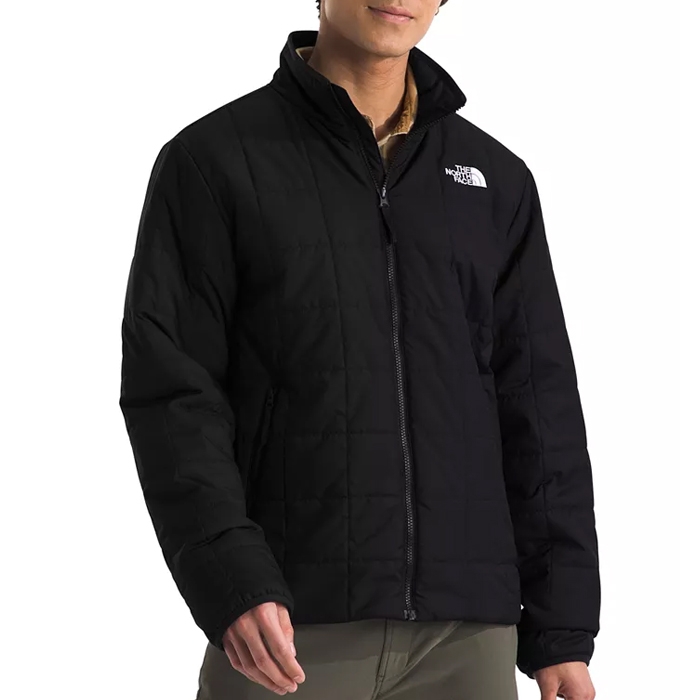 The North Face Men's Junction Jacket is a black, zip-up insulated jacket featuring the brand's logo on the chest. It has a quilted design with a high collar for added warmth.