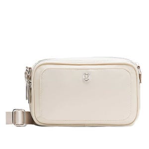 A small white crossbody bag with an adjustable strap, featuring a central logo and a front pocket with a zipper.