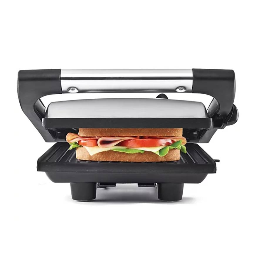 Panini press with a sandwich featuring lettuce, tomato, cheese, and deli meat.